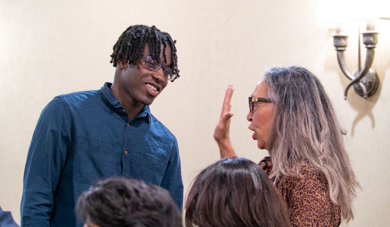 A participant and a facilitator in animated conversation