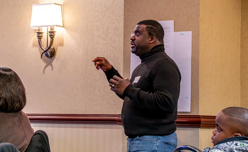 A community leader speaks to the room during a discussion