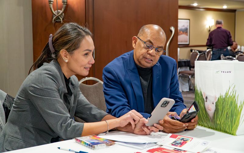 Two participants review resources together at a workshop table